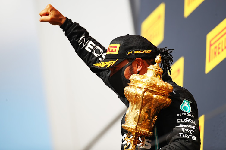 Race winner Lewis Hamilton of Great Britain and Mercedes GP celebrates on the podium during the F1 British Grand Prix at Silverstone on August 2, 2020 in Northampton