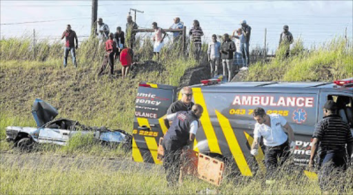 HELP AT HAND: The first paramedics to have arrived on the scene of an accident on the N2 near the Hemingways off-ramp, assist one of the three men who were all flung out of their car when it overturned Picture: ASANDA NINI