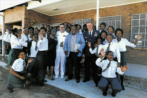 FEELING PROUD: Excitement filled the dusty streets of Mzamomhle as officials from the US Mission to South Africa drove into the township to officially open and hand over the newly renovated Mzamowethu Public School in East London