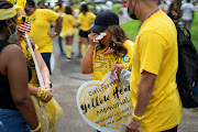 A woman cries as people gather to walk across the Brooklyn Bridge together for those who were lost due to coronavirus disease (COVID-19) in New York, U.S., August 7 2021. 
