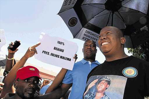 Julius Malema encourages his supporters to support the ANC Youth League yesterday after he was suspended and stripped of the league's presidency Picture: ELIJAR MUSHIANA