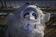 The 2022 Winter Olympic Games' mascot Bing Dwen Dwen, wearing a mask because of the coronavirus disease (Covid-19) pandemic and made of snow, stands outside the ice hockey National Indoor Stadium in Beijing, China, February 16, 2022.  