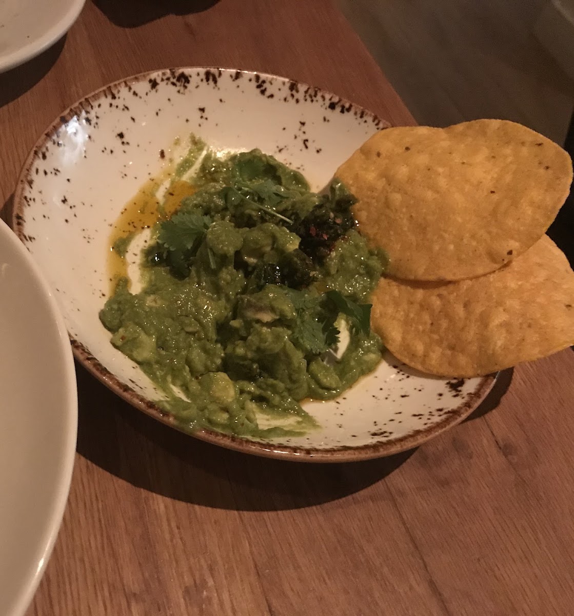 Watercress guacamole appetizer minus two more tostadas since we stared eating. Very good and they give you more tostadas if you run out.