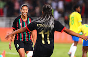 Ibtissam Jraidi (left) of AS FAR celebrates with teammate Fatima Tagnaout after scoring her hat trick in the 2022 Caf Women’s Champions League final against Mamelodi Sundowns at Stade Prince Moulay Abdallah in Rabat, Morocco, on November 13 2022.