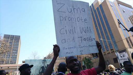 #OccupyLuthuliHouse protester hold a placard 'Zuma promotes War'