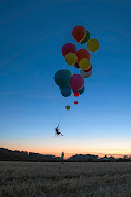 Tom Morgan flew 25km in a camping chair attached to a host of helium balloons.