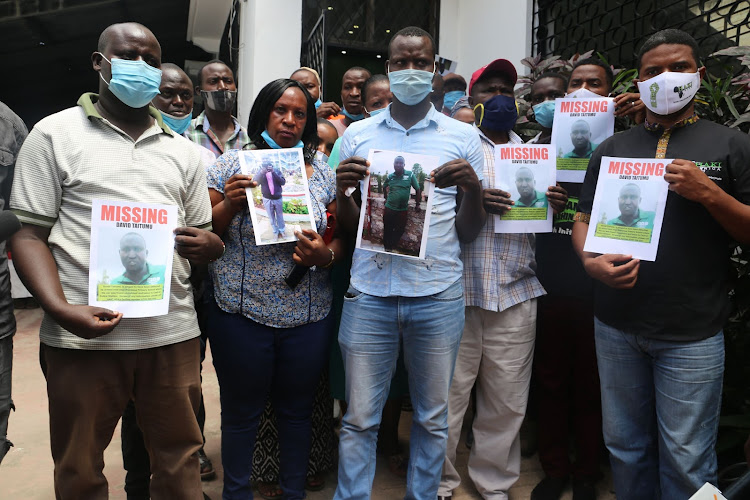 The family of David Taitumu and Haki Africa executive director Hussein Khalid [R] at Haki Africa offices on Tuesday.