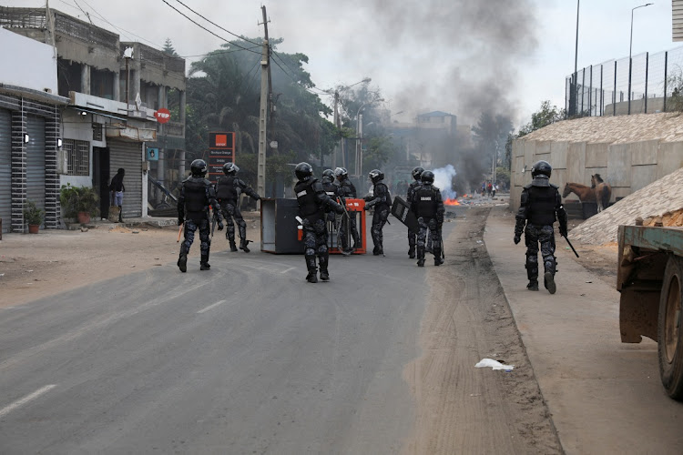 Gendarmes remove an overturned kiosk during protests by supporters of opposition leader Ousmane Sonko, in Dakar, Senegal, July 31 2023. Picture: NGOUDA DIONE/REUTERS