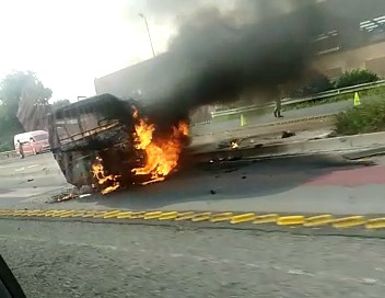 This taxi was carrying 10 passengers when it burst into flames. A woman was pulled to safety after passersby turned the taxi back on to its wheels before it caught fire near Booysens, Johannesburg, on Wednesday morning.