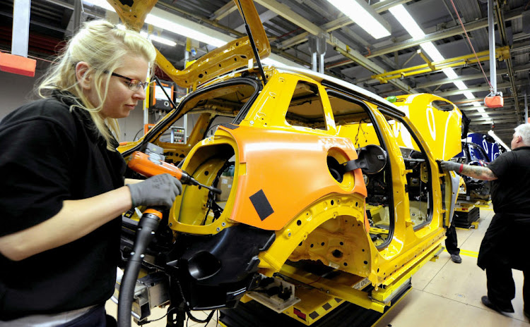 A woman working at a BMW factory producing Minis in Oxford, Britain.