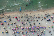 Palestinians enjoy the beach as they escape the heat, in Gaza City July 29, 2022. 