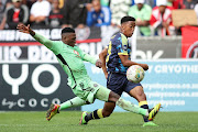 Thabiso Monyane of Orlando Pirates challenges as Heaven Sereetsi of Cape Town City sends a cross during their DStv Premiership match at DHL Cape Town Stadium on Wednesday. Bucs won 2-0.