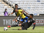 Happy Jele of Orlando Pirates challenges Thabiso Kutumela of Mamelodi Sundowns during the DStv Premiership match between the two sides at Orlando Stadium on September 25, 2021 in Johannesburg