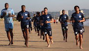 SuperSport United players run on the beach during their training camp in Durban.