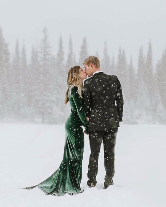 photo of couple kissing in the snow