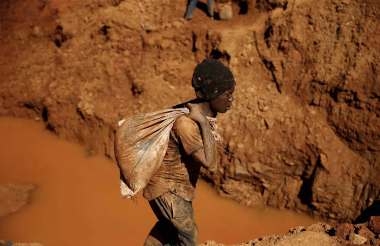 An Illegal artisanal gold miners work at an open mine after occupying parts of Smithfield farm, in Mazowe, Zimbabwe. The state has banned mercury, a chemical used by miners to extract gold.