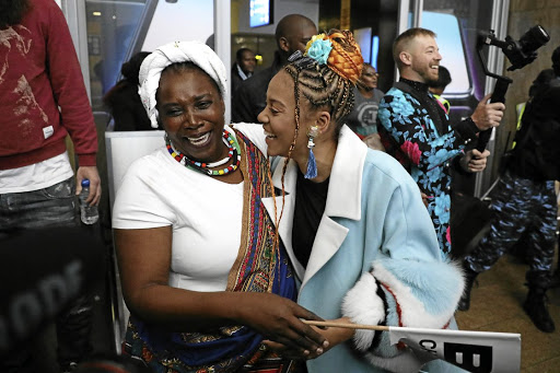 Rapper Sho Madjozi is embraced by her mother Rosemary Phaweni as she arrives at the OR Tambo International Airport from Los Angeles where she bagged a BET award. / Thulani Mbele