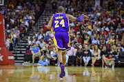 Los Angeles Lakers forward Kobe Bryant (24) celebrates making a three point shot during the game between the Rockets and the Lakers at the Toyota Center. Bryant plays in the last road game and second to last game of his NBA career. 