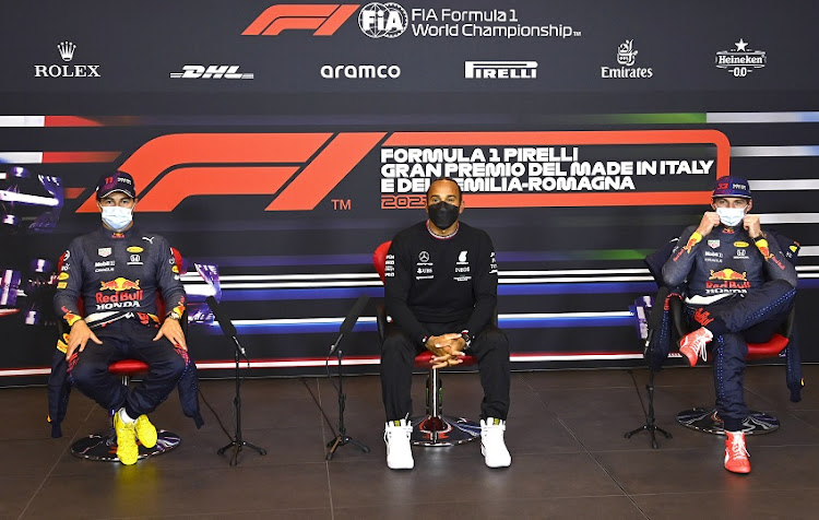 Pole position qualifier Lewis Hamilton of Great Britain and Mercedes GP, Second place qualifier Sergio Perez of Mexico and Red Bull Racing and Third place qualifier Max Verstappen of Netherlands and Red Bull Racing talk during a press conference after qualifying ahead of the F1 Grand Prix of Emilia Romagna at Autodromo Enzo e Dino Ferrari on April 17, 2021 in Imola, Italy.