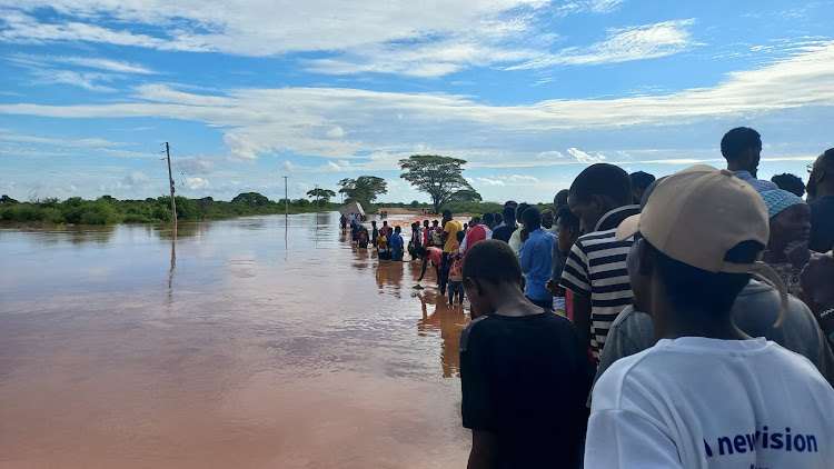 Residents of Madogo and Mororo stare at flood waters that have destroyed the Kona Punda Mororo section.