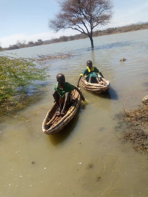 Pupils paddle to school on Lake Baringo, braving crocodiles and hippos as well as choppy water on Monday,