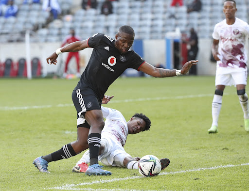 Tshegofatso Mabasa of Orlanda Pirates is challenged by Junaid Sait of Swallows FC during the DStv Premiership match at Orlando Stadium on September 11 2021.