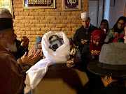 Zainab Bassa (red scarf), wife of Malmesbury mosque victim Ismail Bassa, 74, during prayers at her home on June 14 2018.