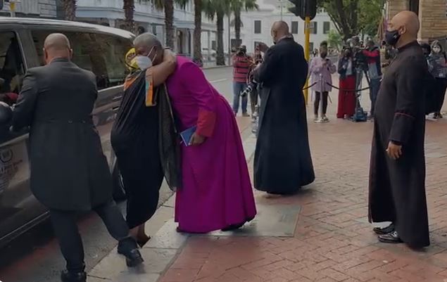 Archbishop Emeritus Desmond Tutu's daughter, Thandeka, embraces Archbishop Thabo Makgoba after arriving with her father's body at St George's Cathedral in Cape Town on December 30 2021.