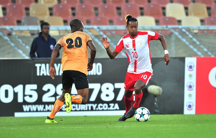 Andriamirado Andrianarimanana of Madagascar challenged by Martin Sikaonga of Zambia during the 2018 COSAFA cup semifinals match between Zambia and Madagascaat Peter Mokaba Stadium, Polokwane on 06 June 2018.