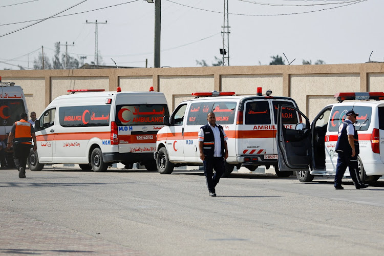 Medical workers wait to take injured Palestinians who will receive treatment in Egyptian hospitals, at the Rafah border crossing with Egypt, in the southern Gaza Strip, November 1 2023. Picture: IBRAHEEM ABU MUSTAFA/REUTERS