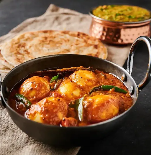 Egg Curry With Lachha Paratha And Rice