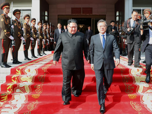 South Korean President Moon Jae-in and North Korean leader Kim Jong Un leave after their summit at the truce village of Panmunjom, North Korea, in this handout picture provided by the Presidential Blue House on May 26, 2018. /REUTERS