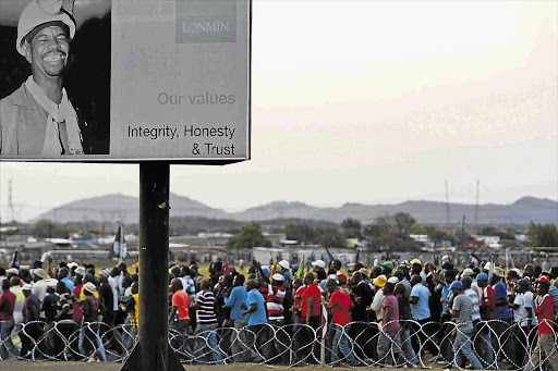 Striking miners at the Wonderkop stadium yesterday accept a new 22% wage increase by Lonmin.