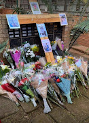 Flowers at the entrance to Northcliff High School in Johannesburg in memory of  Kyle Aiton, 18, who died on Saturday.