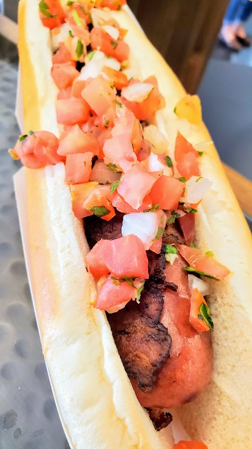 Tocino Pico Dog with bacon wrapped 1/3 lb Zenner's Hot Dog, housemade pico de gallo, available only in the premium Tanner Ridge section from La Hacha Cocina stand, Preview of the New Providence Park After Renovation