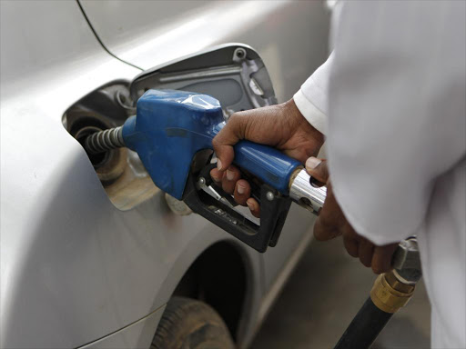 A petrol station attendant fuels a car in Nairobi's CBD. /MONICAH MWANGI