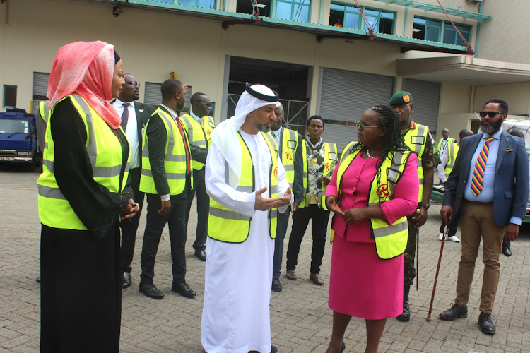 Deputy government spokesperson Mwanaisha Chidzuga [L] looks on as UAE Ambassador to Kenya Dr Salim Ahmed Al-Naqbi has a word with EAC and Regional Development CS Peninah Malonza at Jomo Kenyatta International Airport (JKIA), May 3, 2024.