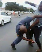 A still image from a recording of the fight between a police constable and a taxi driver.
