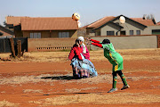 A player from the  G Lovers FC takes the throw-in during  a game against the Phefeni Gogos.