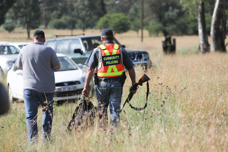 Members of the CPF walk through the veld close to the area where a tiger escaped in Walkerville, south of Johannesburg, on January 16.