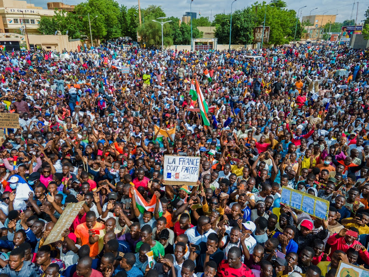 Thousands of anti-sanctions protestors gather in support of the putschist soldiers in the capital Niamey, Niger August 3, 2023. The sign reads "France must go".