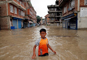 A boy walks along the flooded neighborhood after incessant rainfall in Bhaktapur, Nepal July 12, 2018. File photo 
