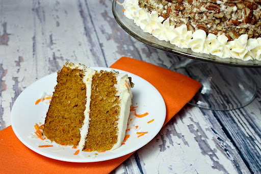 A slice of the best tasting carrot cake on a plate.