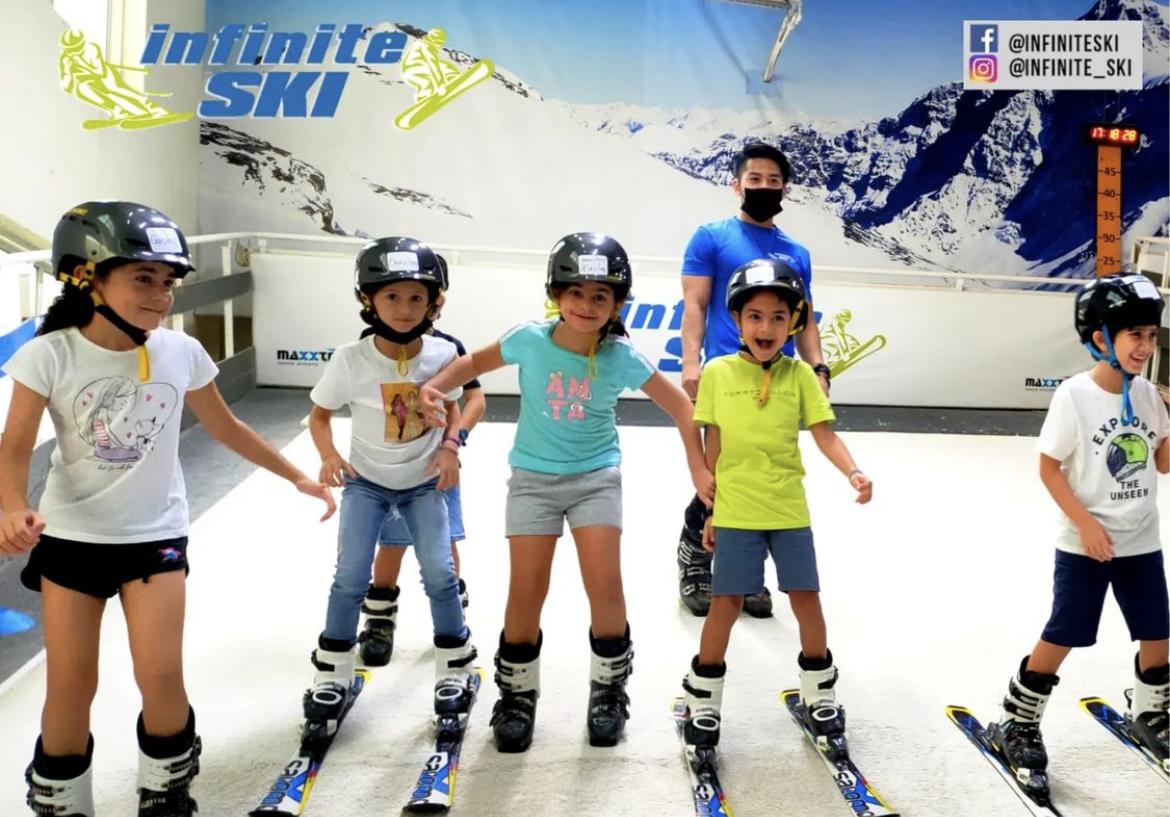 A group of kids wearing helmets and ice skates Description automatically generated with low confidence