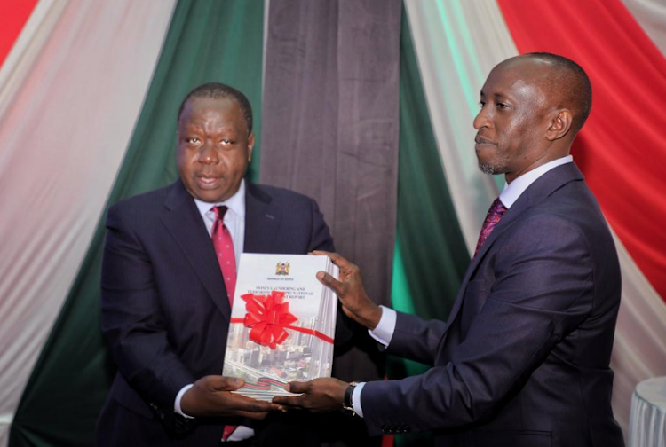 Interior CS Fred Matiang'i with Financial Reporting Centre director general Saitoti ole Maika during the launch of the Money Laundering and Terrorism Financing National Risk Assessment 2021 (NRA) Report/HANDOUT