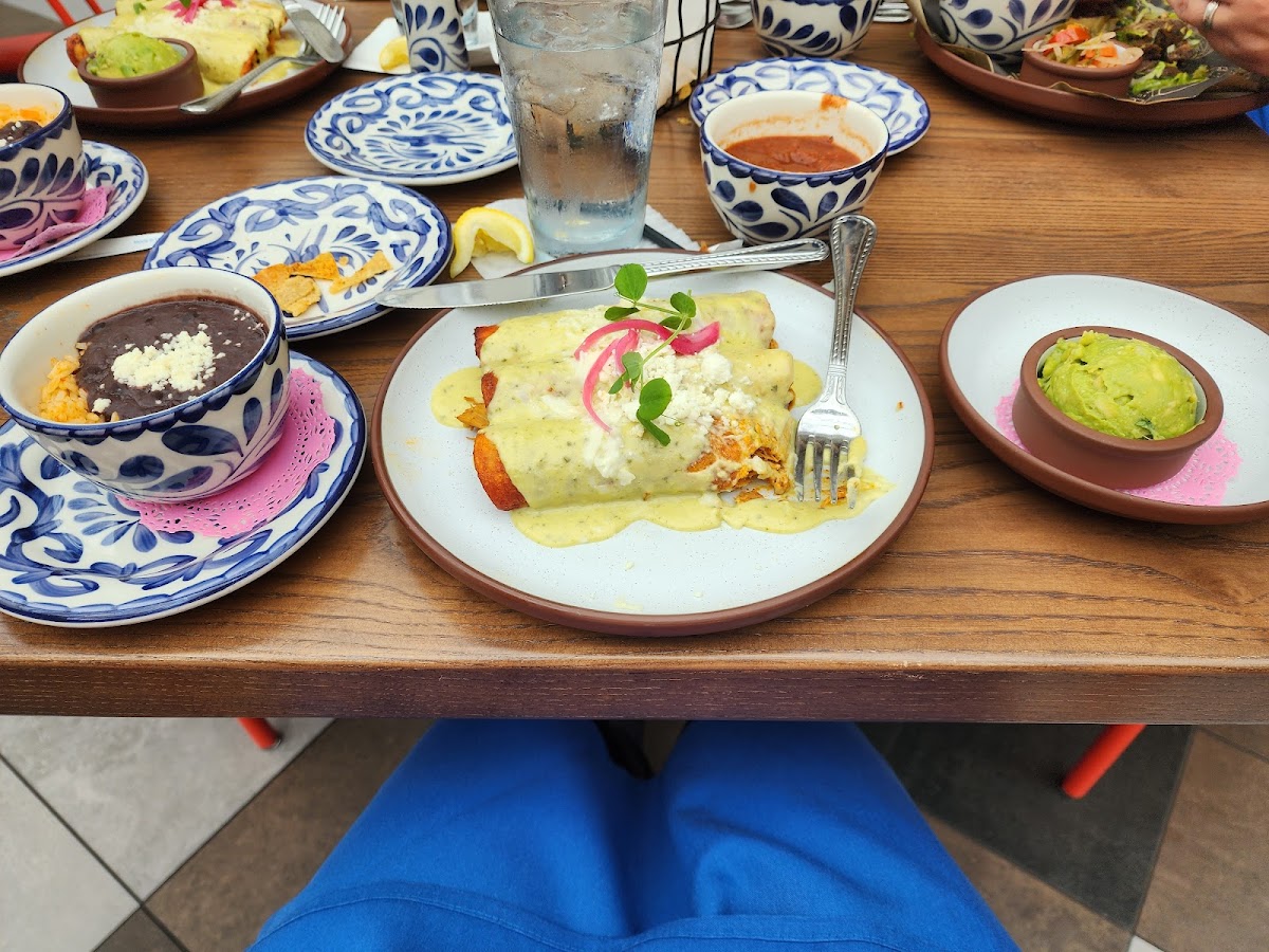 Chicken enchiladas, rice and beans, chips and salsa.