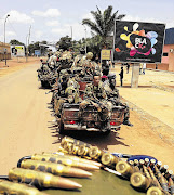 Fighters from the Seleka rebel coalition patrol streets in Bangui in the Central African Republic where 13 South African troops were killed this week at the hands of mutinous government forces