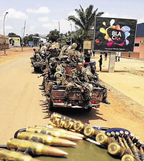 Fighters from the Seleka rebel coalition patrol streets in Bangui in the Central African Republic where 13 South African troops were killed this week at the hands of mutinous government forces