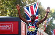 Ethiopia's Sisay Lemma celebrates winning the elite men's London Marathon in London, Britain, October 3 2021. Picture: REUTERS/MATTHEW CHILDS