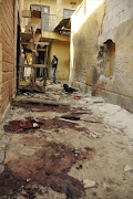 A man stands at the scene of a double suicide bomb attack at the Kantin Kwari textile market in Kano December 10, 2014. Four people were killed and seven injured when two female suicide bombers attacked the Kantin Kwari textile market in Nigeria's second city Kano on Wednesday, a police commissioner said, less than two weeks after militants attacked its main mosque.  REUTERS/Stringer